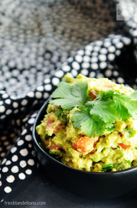 bowl of Kid Friendly Guacamole with black and white napkin in background