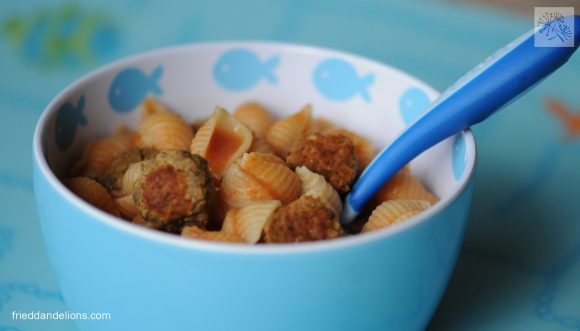 blue bowl of vegan spaghettios with blue spoon