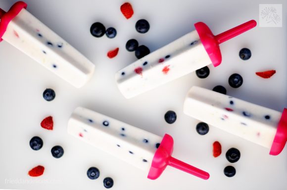 4 Firecracker Popsicles overhead shot horizontal with berries in white background