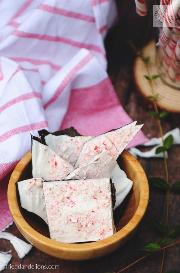 bowl of dairy free peppermint bark with candy canes in the background