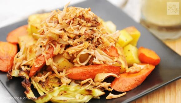 plate of vegan corned jackfruit with roasted carrots and cabbage