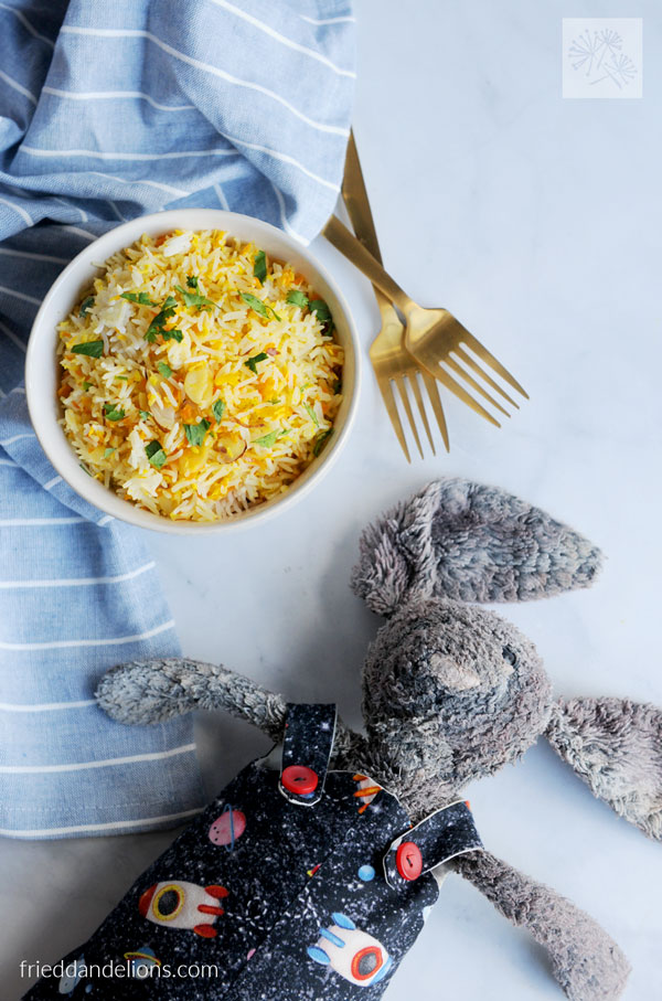 overhead view of bowl of Coconut Carrot Rice with stuffed bunny