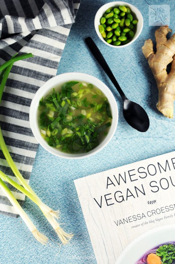 overhead view of edamame miso soup with cookbook Awesome Vegan Soups