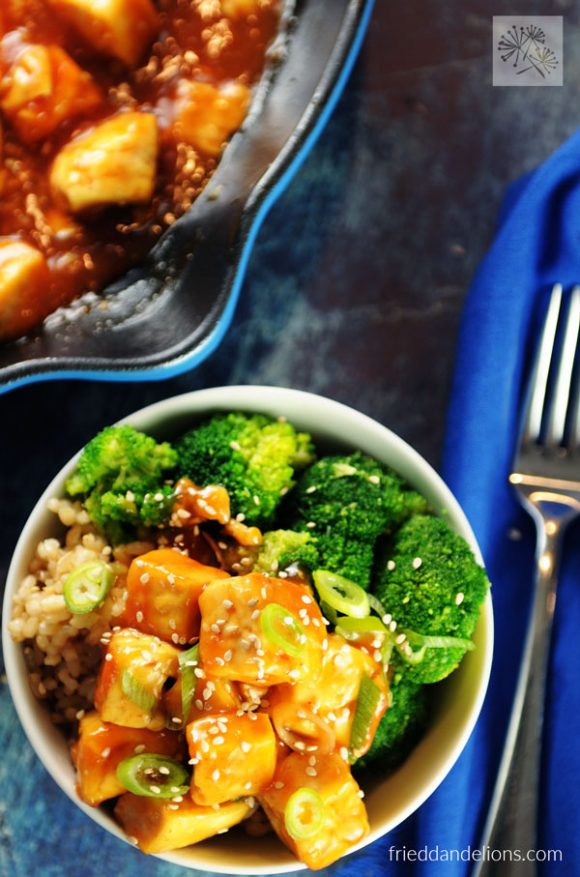 overhead view of sweet and sour tofu with blue pan full of tofu in background