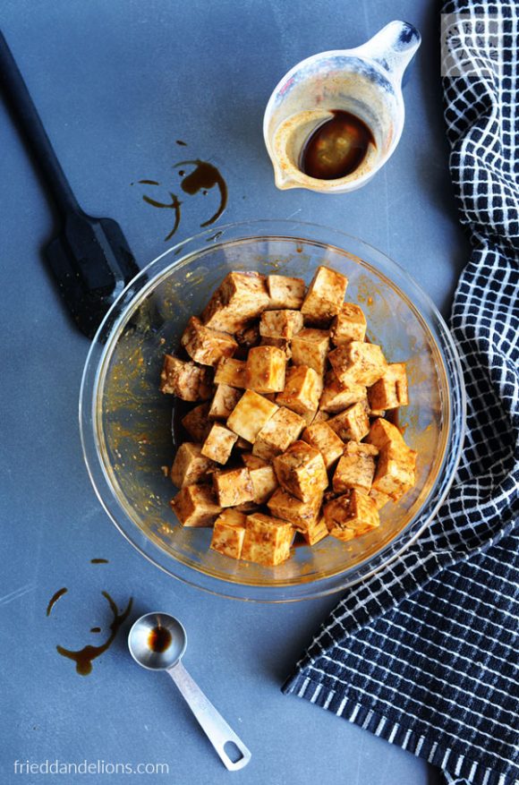 bowl of tofu being marinated in hoisin sauce for Fried Tofu with Hoisin and Peanut Sauce Noodles