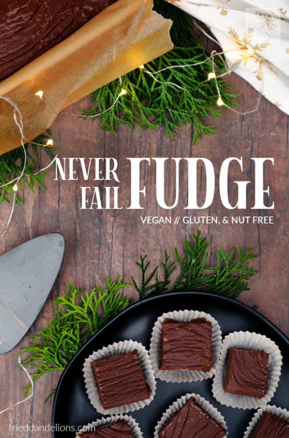 overhead shot of vegan never fail fudge on brown wood table with greens, christmas lights, and text overlay