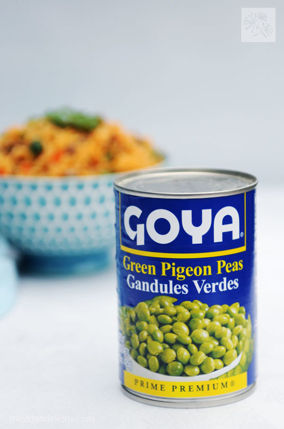 can of pigeon peas with bowl of arroz con gandules in background