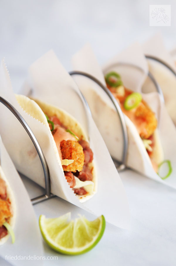 close up view of Vegan Crispy Chicken Tacos with lime wedge in foreground