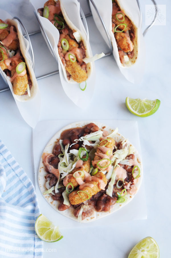 overhead view of Vegan Crispy Chicken Tacos with one open faced taco in foreground