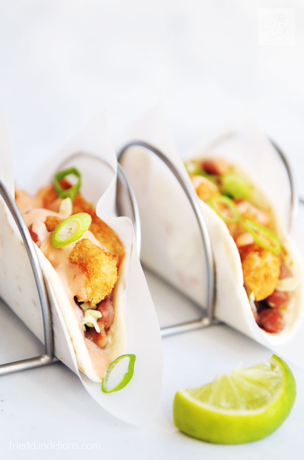close up view of Vegan Crispy Chicken Tacos with lime wedge in foreground