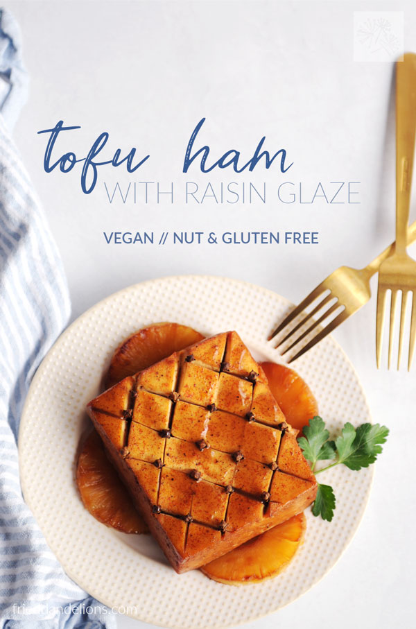 overhead view of Vegan Tofu Ham with Raisin Glaze with text overlay, gold silverware, white plate
