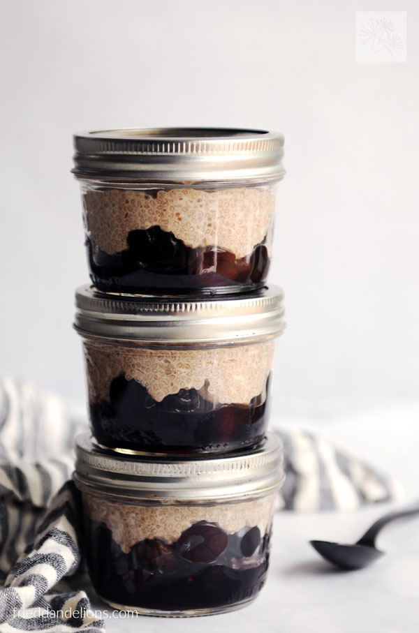 stack of 3 jars of cherry chia pudding ready to go for early morning breakfast