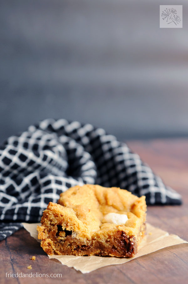 s'mores cookie bar with black and white dishtowel in the background