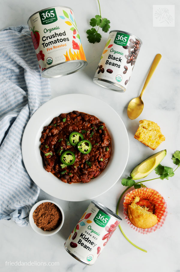 pantry staple ingredients for easy vegan chili—black beans, kidney beans, crushed tomatoes, cocoa powder